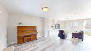 Living area with light hardwood / wood-style floors