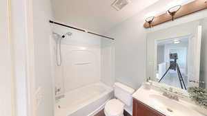 Full bathroom featuring bathing tub / shower combination, vanity, and toilet