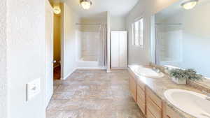 Bathroom featuring shower / tub combo with curtain and vanity