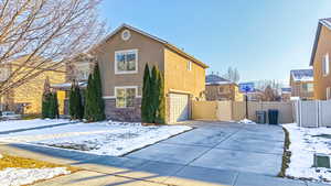 View of snow covered exterior with a garage