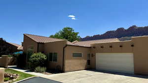 View of front of home with a garage and a mountain view