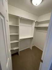 Walk in closet of primary bedroom