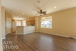 Unfurnished living room featuring dark lvp flooring and ceiling fan