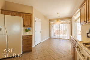 Kitchen featuring lightt tile patterned floors, white appliances