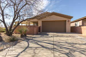 View of back of home featuring a garage