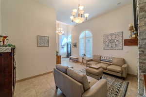 Tiled living room featuring a chandelier