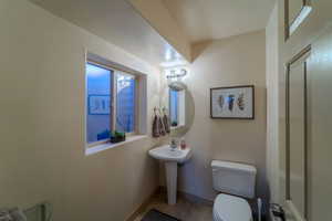 Bathroom with tile patterned flooring, sink, and toilet