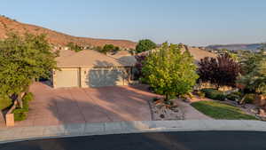 View of front of property with a garage and a mountain view