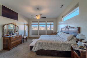 Carpeted bedroom with ceiling fan and access to exterior