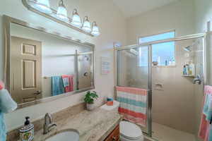 Bathroom with walk in shower, vanity, and toilet