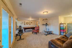 Exercise area with carpet floors and billiards