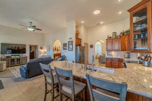 Kitchen featuring stainless steel appliances, sink, a kitchen breakfast bar, and kitchen peninsula