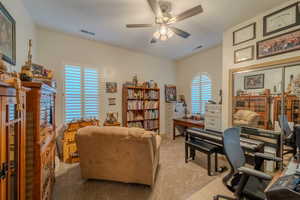 Carpeted office space with ceiling fan