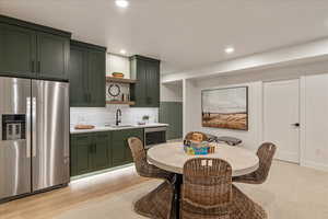 Dining area featuring sink and light hardwood / wood-style floors