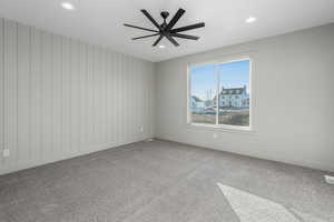 Empty room with ceiling fan and carpet