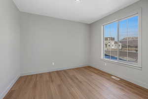 Unfurnished room with light wood-type flooring