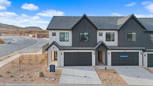 View of front of home featuring a garage and a mountain view