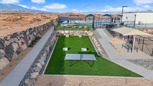 View of property's community with a mountain view and a lawn