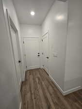 Corridor with dark hardwood / wood-style floors