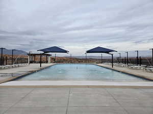 View of swimming pool with a mountain view and a patio area