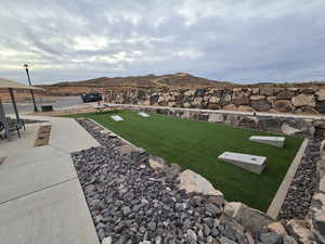 View of yard with a mountain view and a patio area