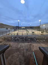 View of yard featuring a mountain view and tennis court