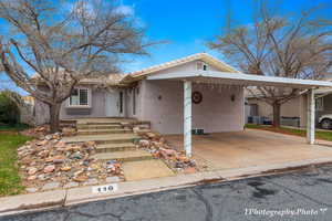 View of front of house with a carport