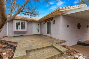 Property entrance featuring a patio area