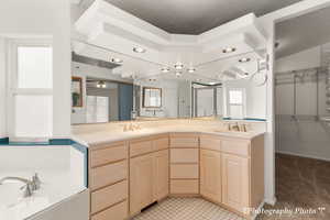 Bathroom with vanity and a textured ceiling