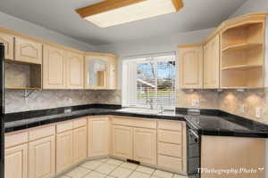 Kitchen featuring sink, light brown cabinets, and light tile patterned floors