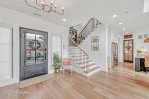 Foyer featuring a notable chandelier and light hardwood floors