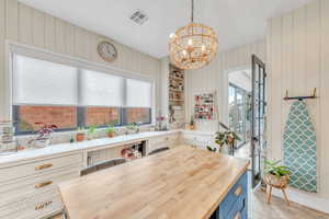 Kitchen featuring a chandelier, a healthy amount of sunlight, pendant lighting, and 2 seating options