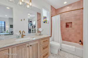 Full bathroom featuring vanity, tile patterned flooring, shower / bath combination with curtain, and toilet