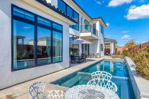 View of pool with a patio and pool water feature