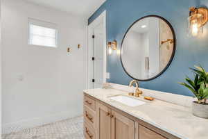 Bathroom featuring walk in shower and vanity