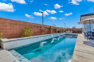 View of pool featuring a patio and pool water feature