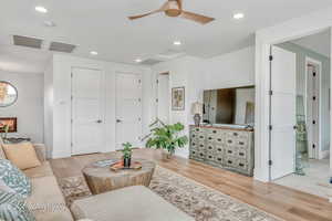 Second Living room with ceiling fan and light wood flooring