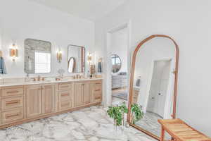 Bathroom with a towering ceiling and vanity