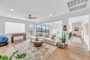 Second Living room with ceiling fan and light hardwood floors