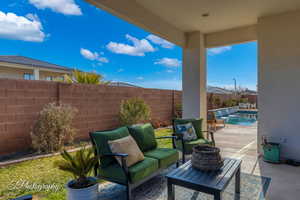 View of patio / terrace featuring a fenced in pool, an outdoor hangout area, and pool water feature