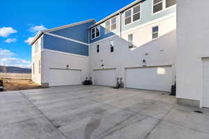 View of property exterior featuring a mountain view and a garage