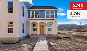 View of front facade featuring fence, a shingled roof, covered porch, and a mountain view