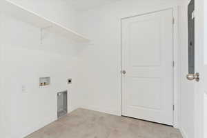 Laundry area with electric dryer hookup, light tile patterned floors, and hookup for a washing machine