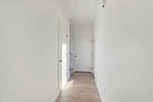 Hallway featuring light wood-type flooring