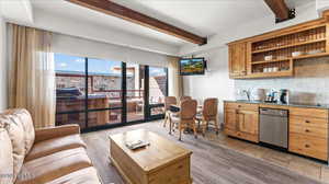 Living room with sink and beam ceiling