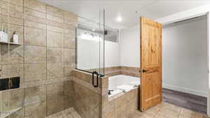 Bathroom with tile patterned flooring and separate shower and tub