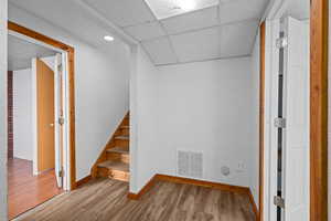 Interior space with wood-type flooring and a drop ceiling