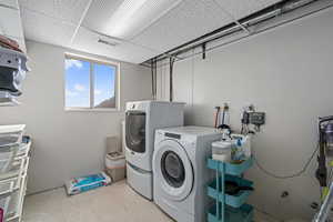 Clothes washing area featuring washing machine and clothes dryer