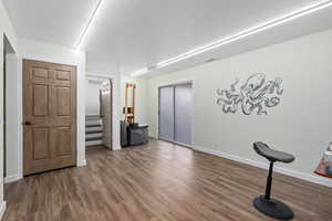 Workout area featuring hardwood / wood-style flooring