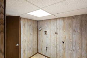 Laundry room featuring hookup for a washing machine and wooden walls